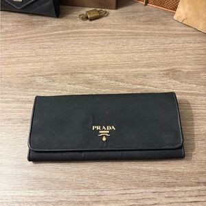 Prada Black Clutch wallet with Gold Accents
Prada tessuto